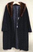 A ladies 1950's black Astra fur coat with a brown fur collar,