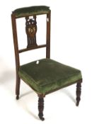 An early 20th century mahogany chair, upholstered in a green fabric,