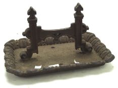 A 19th century iron shoe scraper, mounted on a rectangular base with a fluted edge,