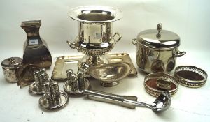 A collection of silver plate, including an ice bucket, shakers, a vase, coasters and more,