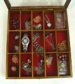 An assortment of costume jewellery and watches, including floral pendants, necklaces,
