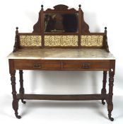 A Victorian mahogany washstand, the frame with a mirror surrounded by carved cresting,