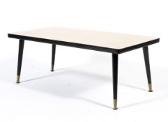A vinyl topped mid century coffee table on splayed legs with brass feet