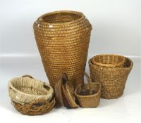A large collection of wicker, including baskets, bowls and a hamper,