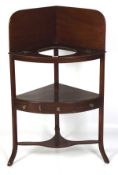 A Georgian mahogany corner wash stand, the upper section with three bowl receptacles,