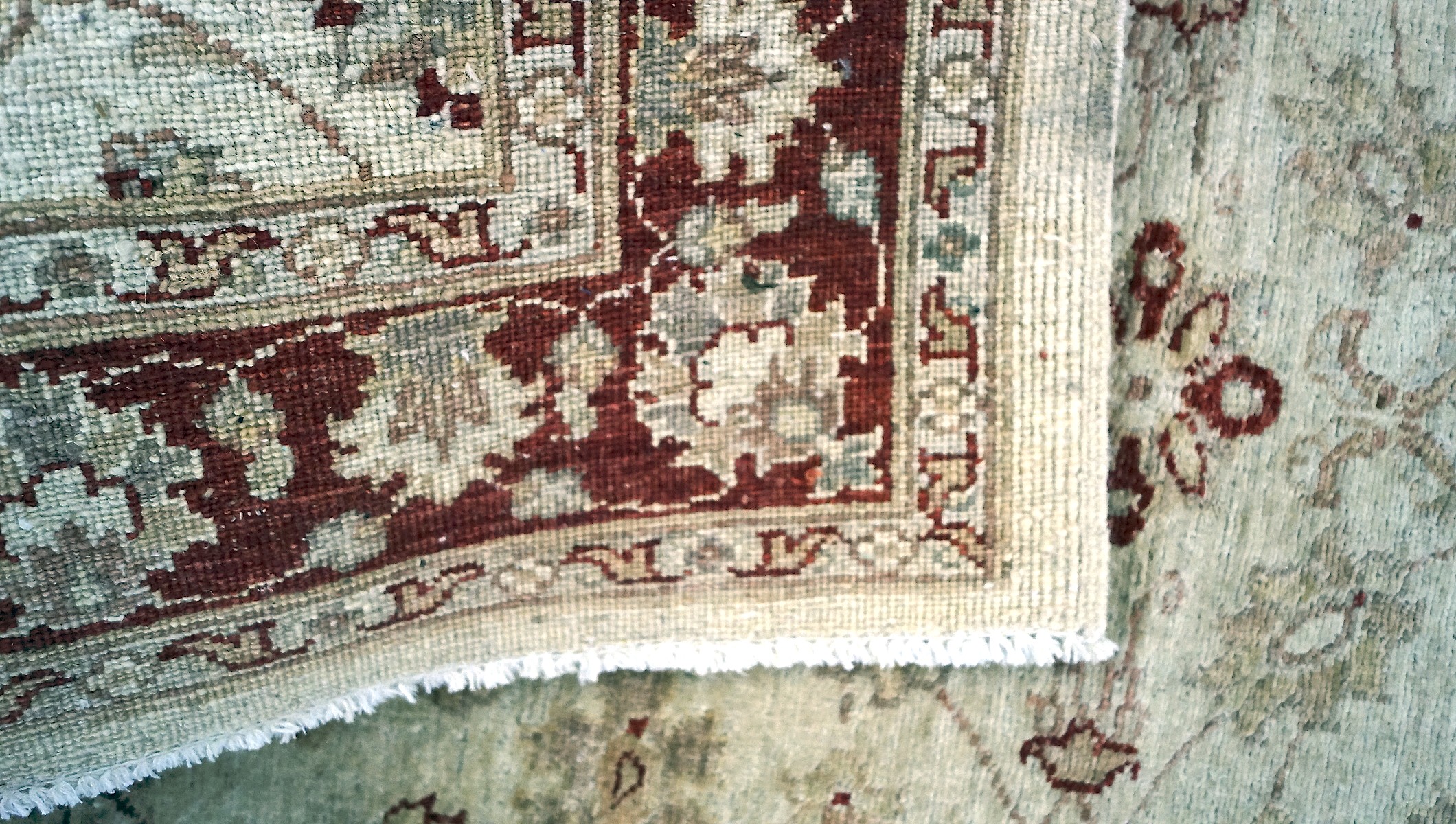 A woven Eastern rug, decorated with floral patterns on a beige ground, encircled by a red border, - Image 3 of 3