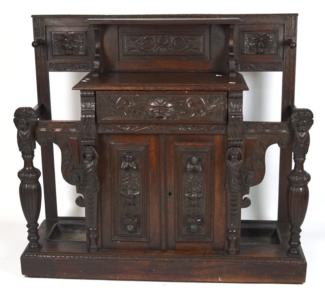 A 19th century oak hall stand, with highly carved decoration throughout,