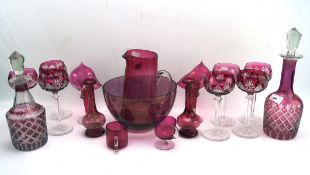 A collection of assorted red glassware, some being cranberry examples,