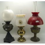 Three early 20th century oil lamps,