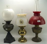 Three early 20th century oil lamps,