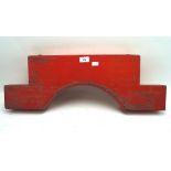 A wooden barrel holder, painted in red,