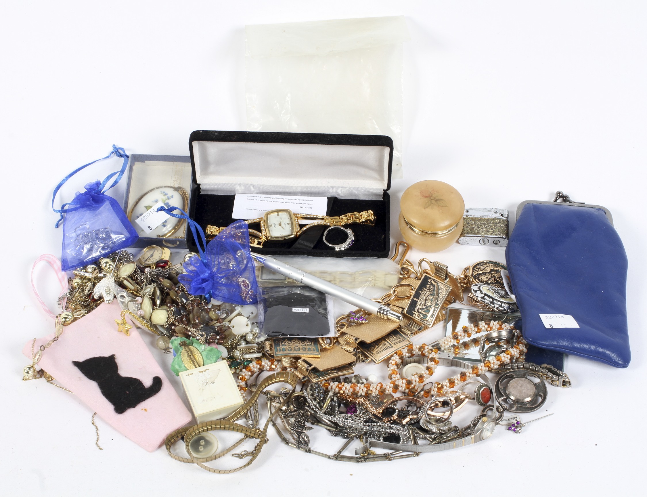 A selection of costume jewellery, including floral brooches, a pendant, a Pigeon lighter,