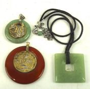 Two Chinese Jade pendants and a similar hardstone pendant,