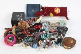 A large quantity of costume jewellery, including necklaces, a metal bangle, assorted beads and more,