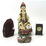 Four oriental and chinoiserie collectables, including a ceramic figure in a seated pose,