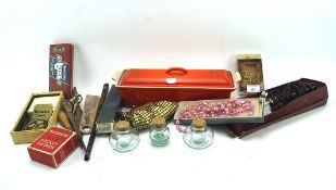 An assortment of collectables, including a Broad Caster mouth organ,