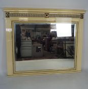 A contemporary white framed over mantle mirror,