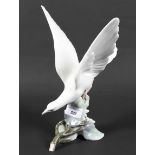 A large Lladro porcelain figure depicting a bird about to take flight,