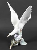 A large Lladro porcelain figure depicting a bird about to take flight,