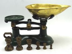 A vintage set of green painted Thomas Plant scales, together with associated set of weights,