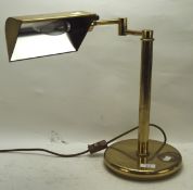 A contemporary adjustable brass desk lamp,