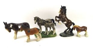 Four ceramic horses and a donkey, including a Beswick model of a rearing horse