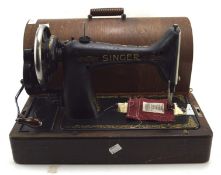 A vintage singer sewing machine in case,