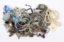 A selection of costume jewellery, including brooches, charms, rings,