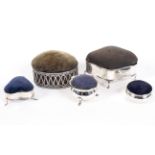 A selection of five silver pin cushions, of various designs,
