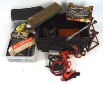 A large assortment of car tools, including a dent repair kit, battery tester, plugs and more,