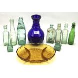 A collection of glassware, including a selection of vintage glass bottles,