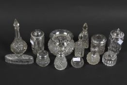 A large selection of silver and white metal mounted glass bottles, mostly early 20th century,