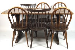 A stained oak refectory style dining table and six related chairs,