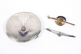 A silver RAF compact and two military pins,