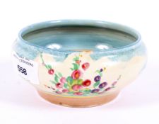 An Art Deco Clarice Cliff bowl, decorated with floral sprigs and bushes,