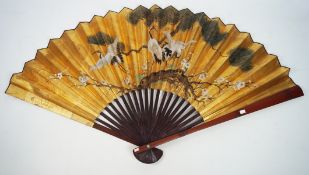 A contemporary Chinese folding fan, the paper leaf decorated with herons on a gold ground,