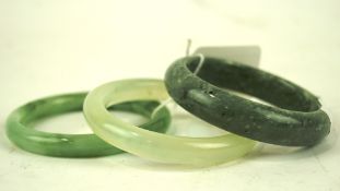 Two Chinese Jadeite bangles and a similar hard stone example,