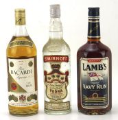 Three vintage bottles of alcohol, including a bottle of Pierre Smirnoff vodka,