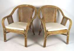 A pair of 20th century bamboo and wicker upholstered armchairs,