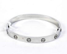 A reproduction Cartier eternity bracelet, white metal,