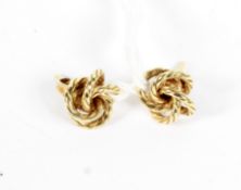 A pair of yellow metal ladies stud earrings in the form of knots,