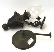 A Victorian brass wall mounted oil lamp, the adjustable frame featuring a dragon,