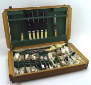 An Art Deco wooden canteen containing a selection of cutlery,