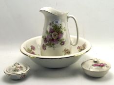 An Empire Works Stoke on Trent wash jug and basin set decorated with roses on a cream ground,