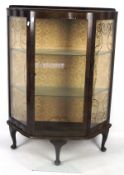 A 20th century stained veneer display cabinet, raised upon cabriolet supports,