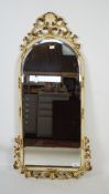 A late 19th/early 20th century gilt and white painted gesso wall mirror,