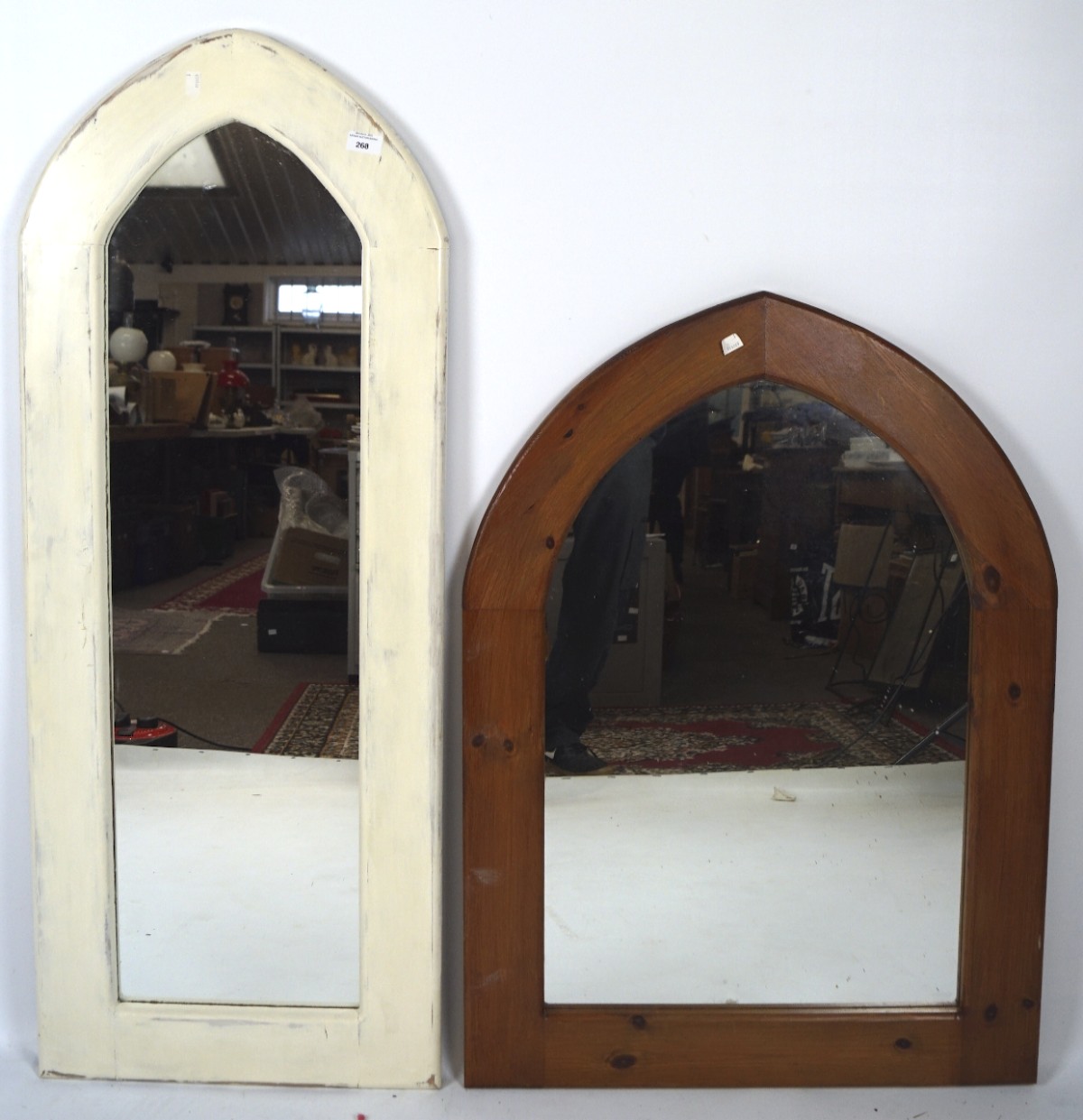 Two contemporary wooden wall mirrors both with arched top, one painted white,