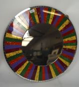 A contemporary multi coloured glass wall mirror, of circular form,