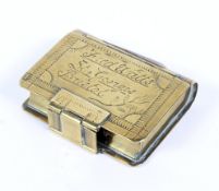 A 19th century brass snuff box in the form of a book,