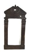 A heavy carved wood frame,